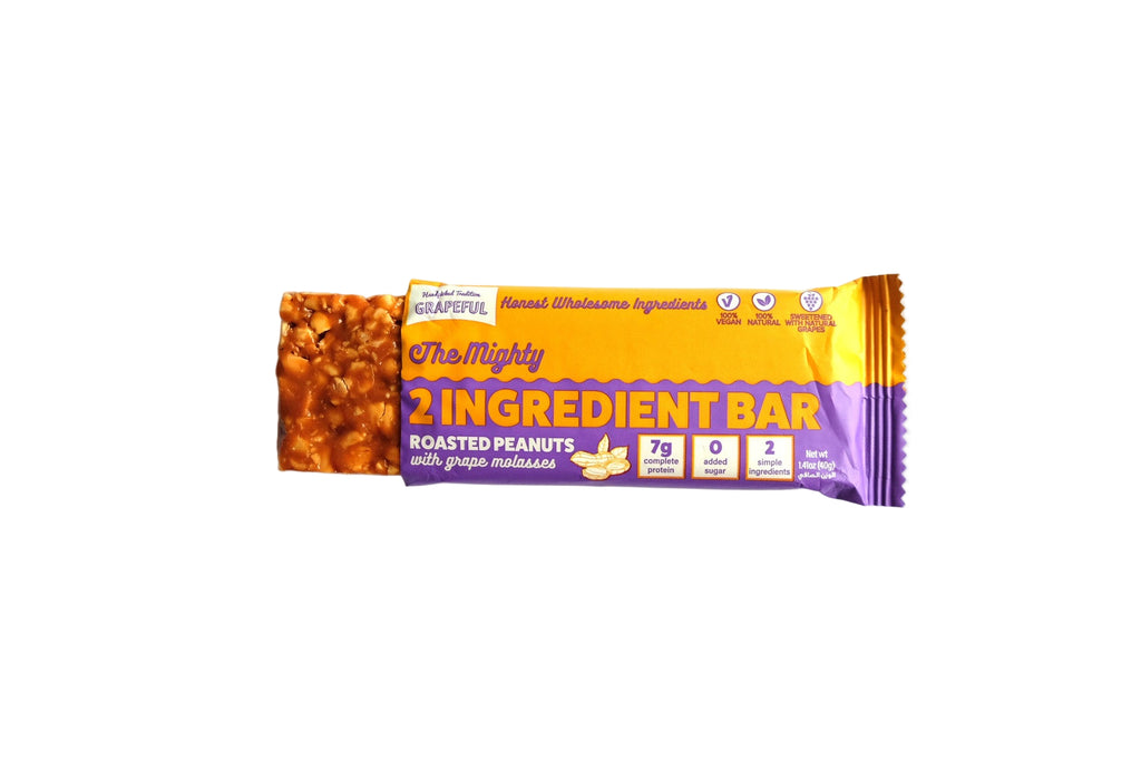 Naturally Beautiful 2 Ingredient Bar with roasted peanuts on a white background